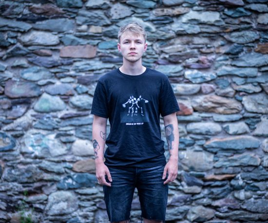 Young person in front of wall